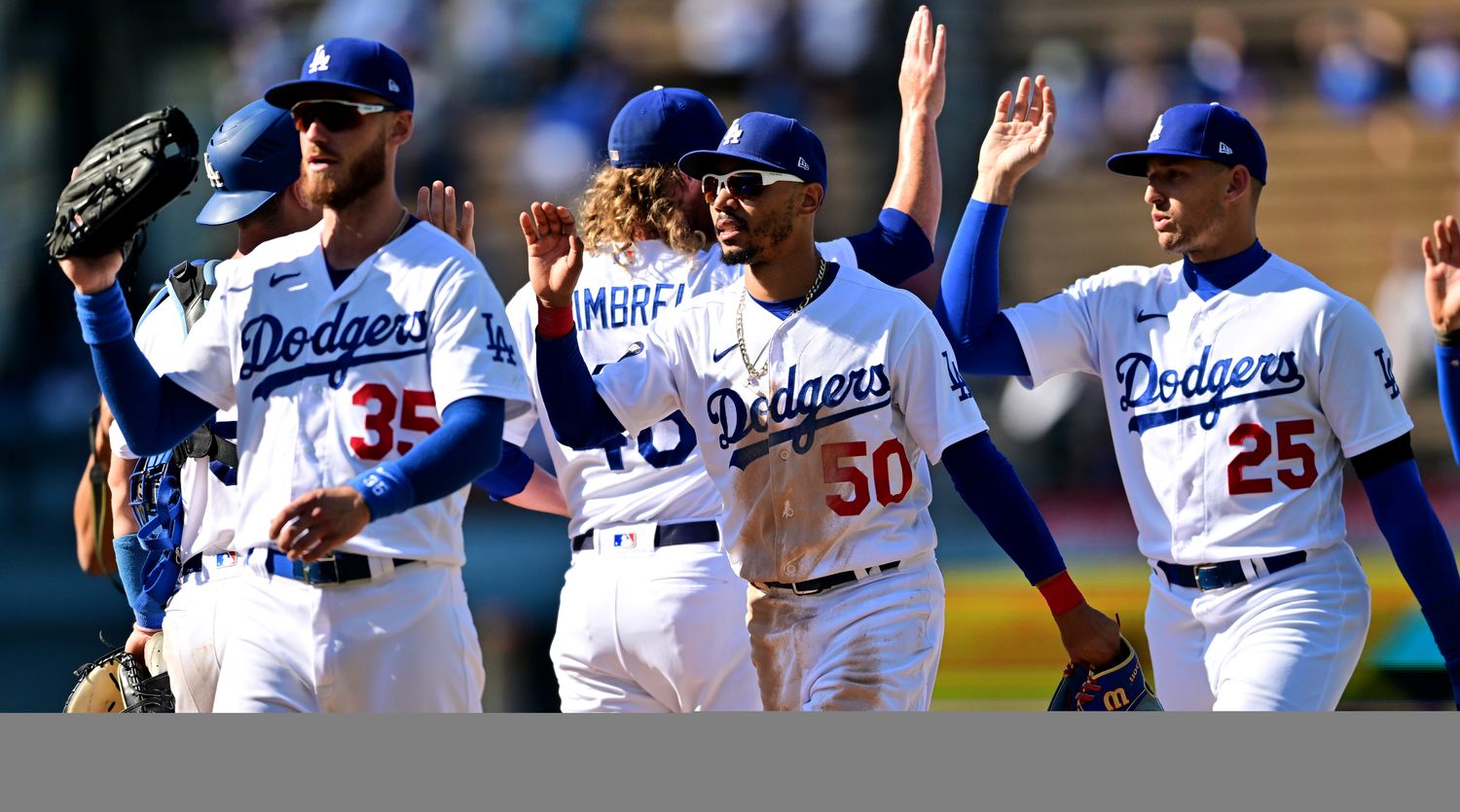 Aug 21, 2022; Los Angeles, California, USA;  Los Angeles Dodgers center fielder Cody Bellinger (35), right fielder Mookie Betts (50) and left fielder Trayce Thompson (25)  celebrate the victory against the Miami Marlins at Dodger Stadium.